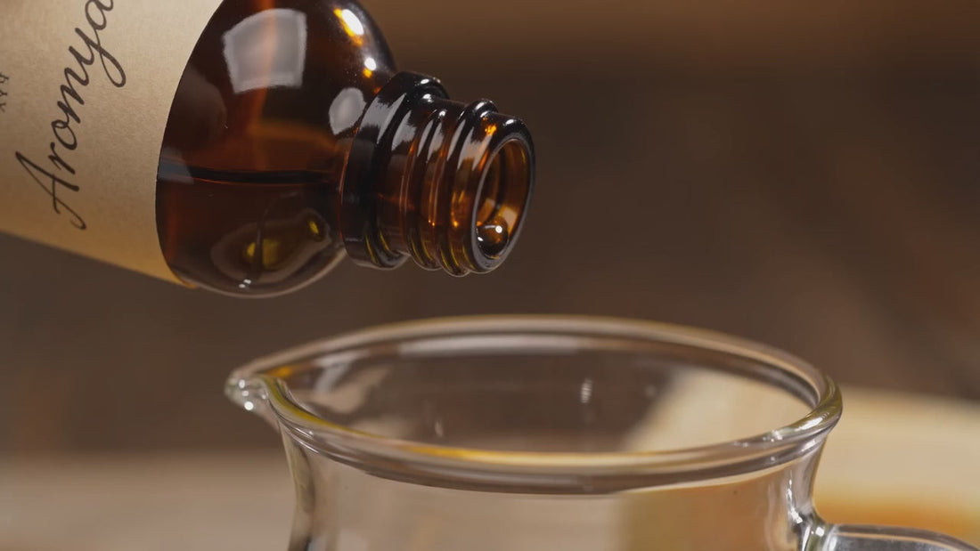 Pouring Aromya fragrance oil for candle and soap making
